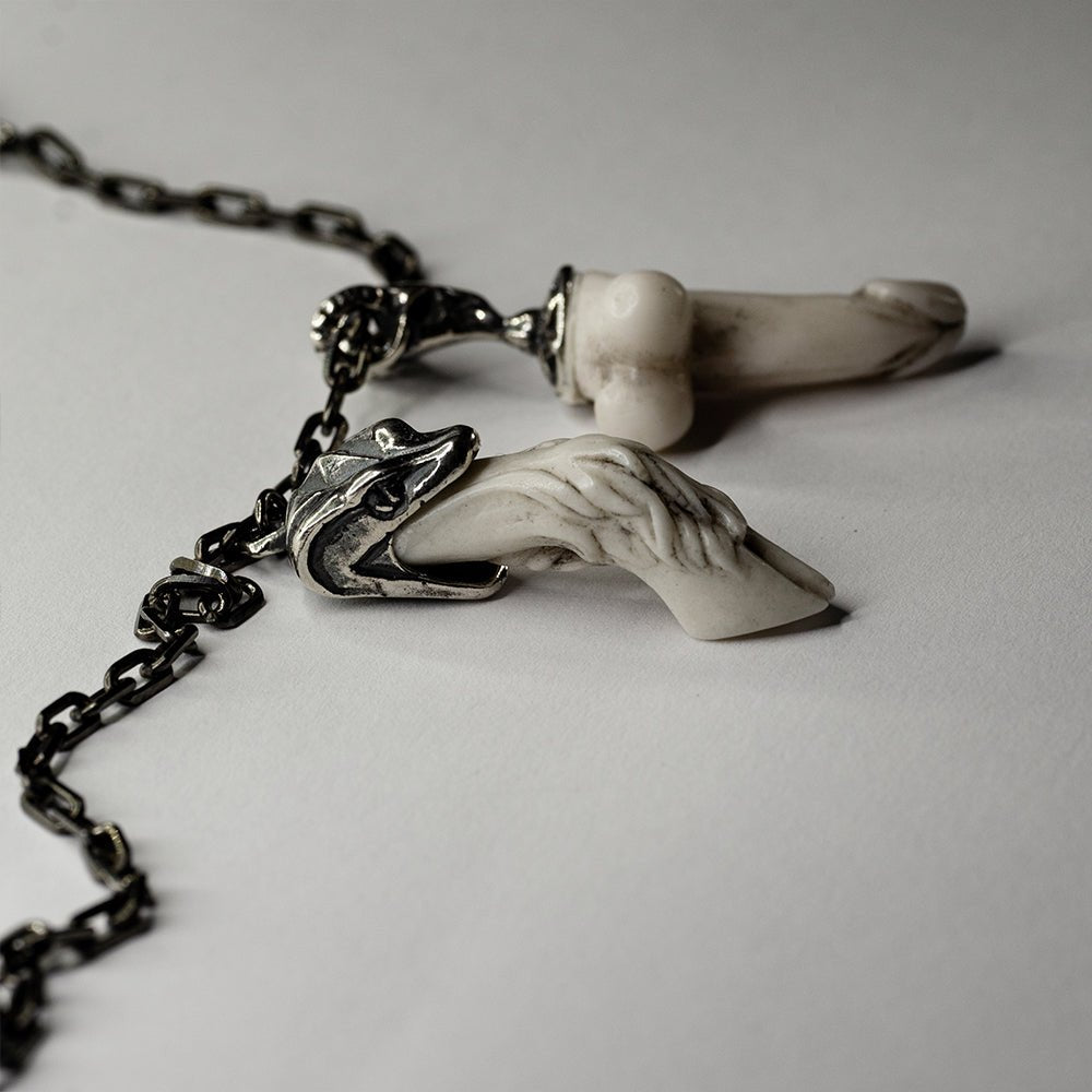 Faun Bracelet - close up of both charms, focus on the detailed relief on the hoof and on the fertility symbol