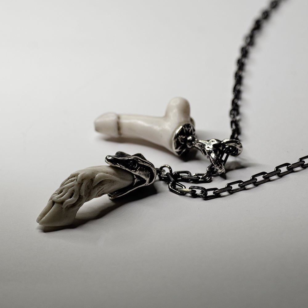 Faun Bracelet placed on a white surface, clear view on both charms and sterling silver holders with detailed decoration