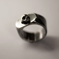 Flow ring - sterling silver gothic signet ring with the skull ornament on neutral surface