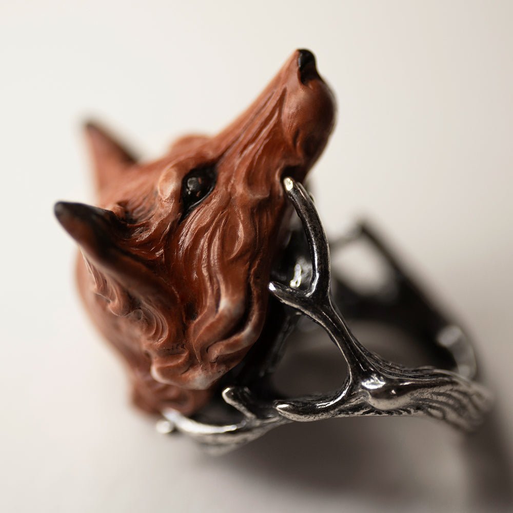 Fox ring - on a white background, focus on marble foxes head and sterling silver twigs details of the ring