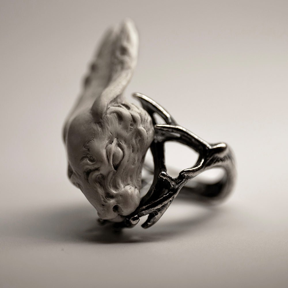 Hare ring - white variant - on a white surface, with contrast light complementing detailed relief, like fur curls and eyes shape