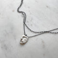 Heracles pendant - silver variant - placed on white marble surface
