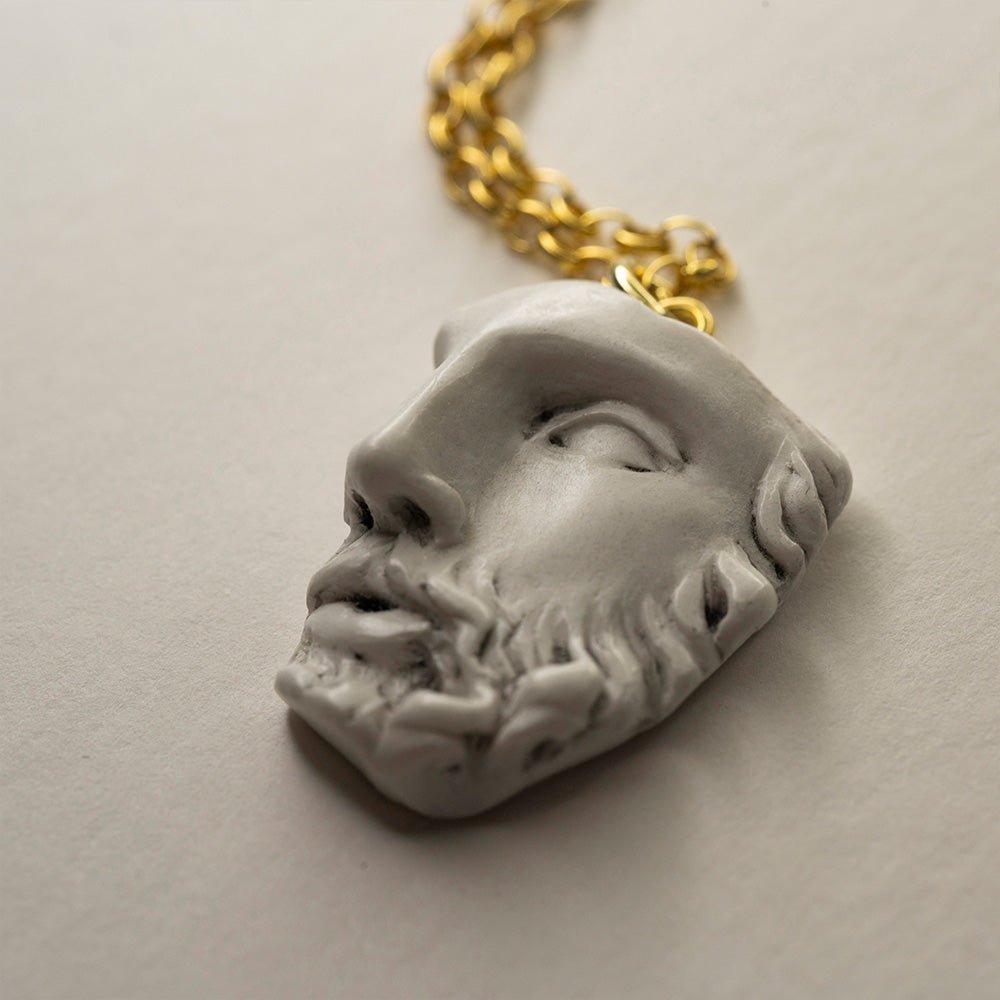 Heracles pendant - close-up of marble charm detail, focus on sculpted details