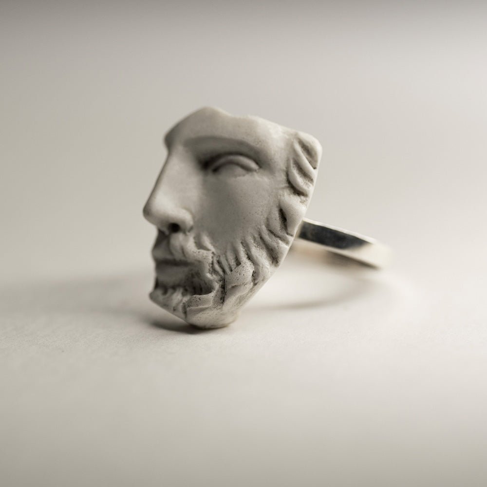 Heracles ring - sculptured face ring set on modern minimalist band on neutral background