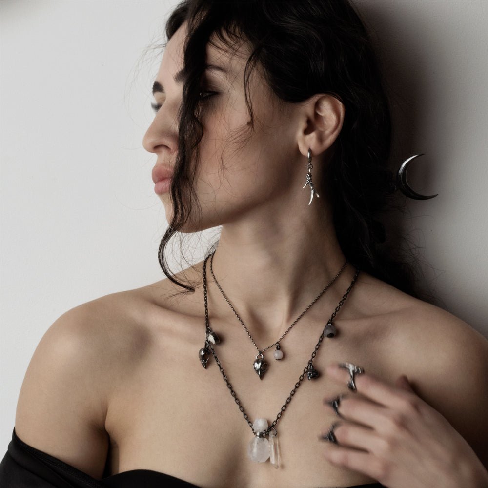 Female model wearing Horn earring along with other jewelry by Macabre Gadgets, gothic jewelry styling shot