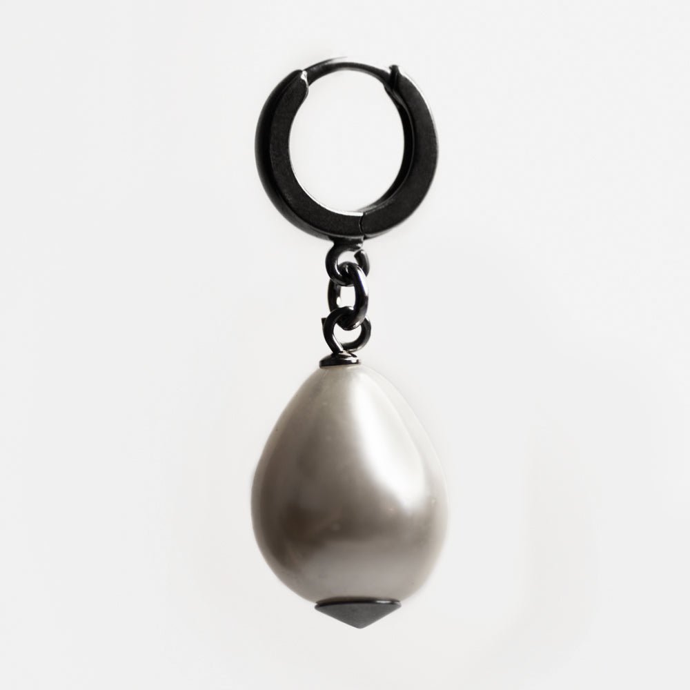 Large pearl earring  - placed against white background