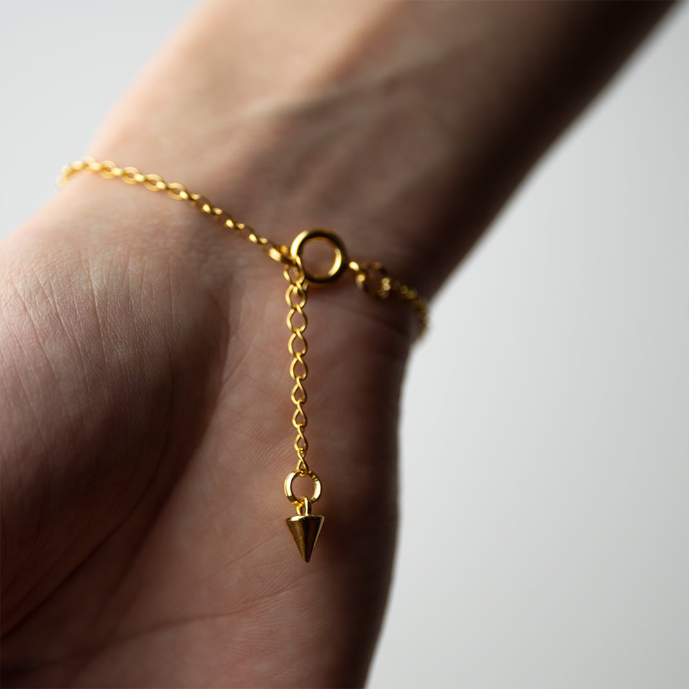 Marble Bracelet - gold variant - on a wrist, from the back of the hand, shows lobster clasp and size adjustable chain