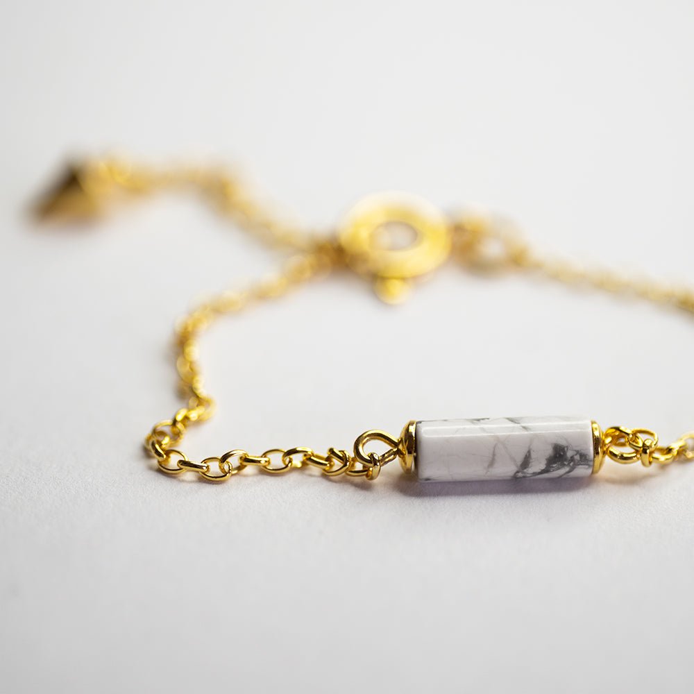Marble Bracelet - gold variant - placed on a white surface, close up of howlite detail