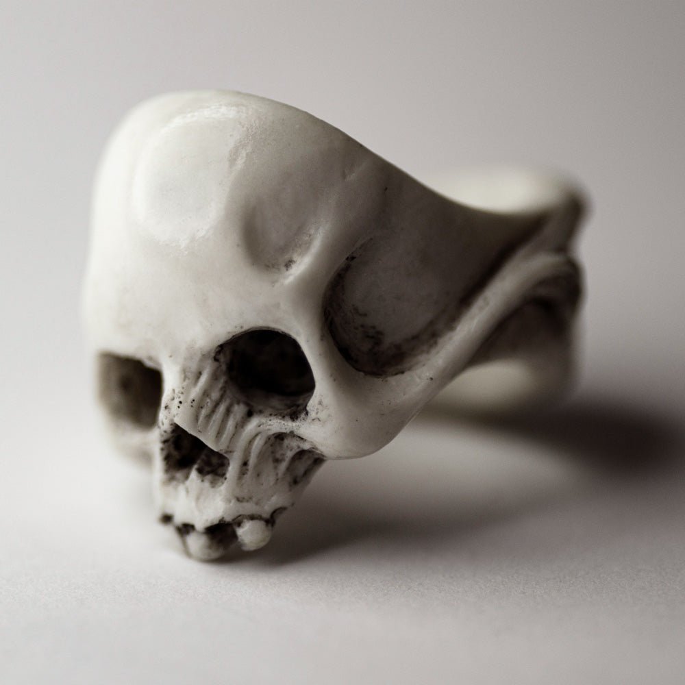 Skull ring - white marble no jaw skull ring on neutral background