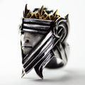 This image features a striking men's ring known as the "Mars ring." The ring is intricately designed with a bold, oxidized sterling silver structure that portrays a face wearing a helmet, incorporating both traditional and modern styling.