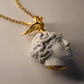 Medusa pendant - close-up of sculpture like marble pendant wit gold - plated silver details, boho style charm necklace