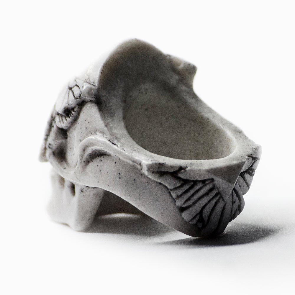 Moths skull ring on neutral background - view from the back