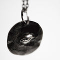 Close-up of Silver Eye Pendant - gothic coin charm with an eye motif