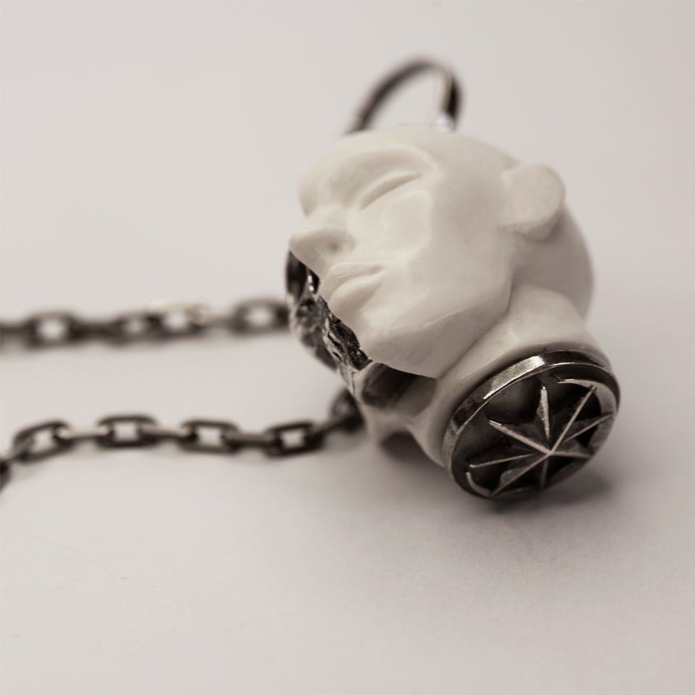 Oracle Skull pendant - placed on a white surface on its side