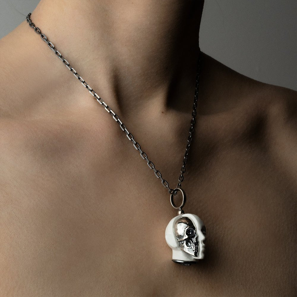 Oracle Skull pendant - on a female model, close-up, semi-profile view