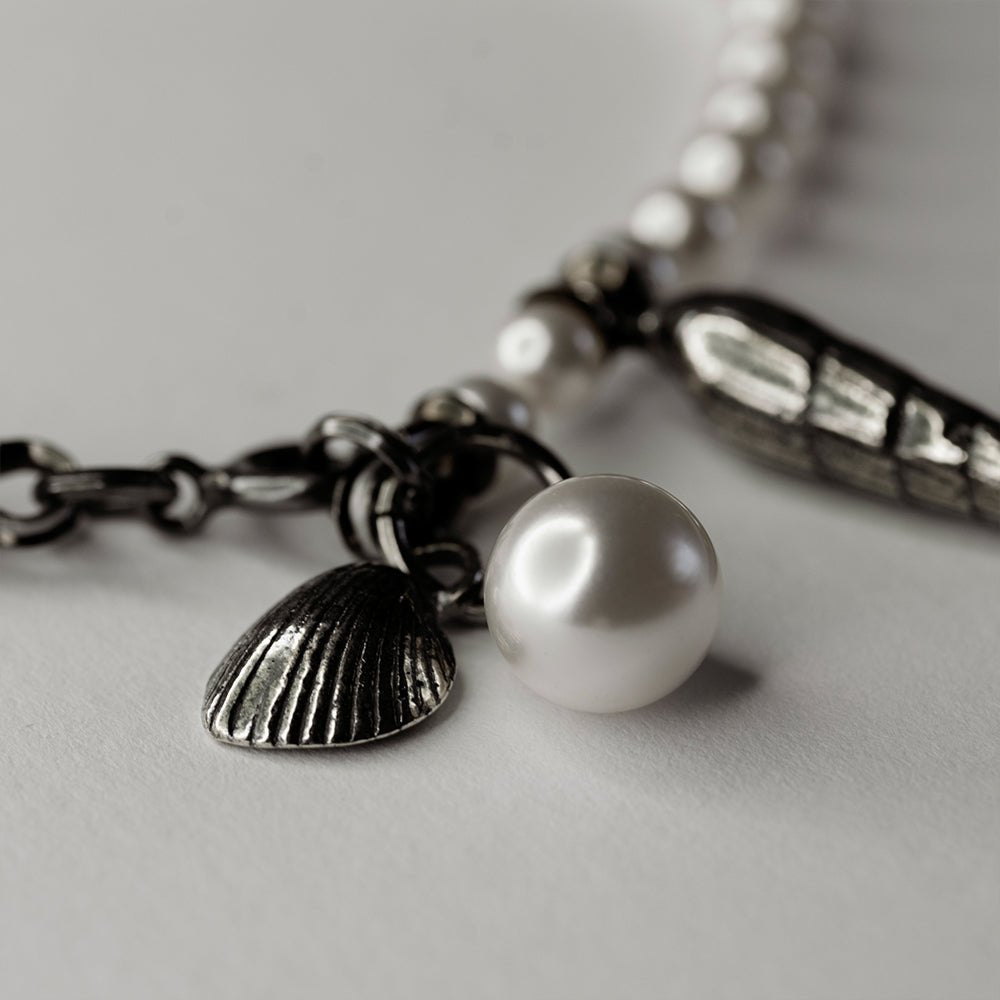 Pearl & Shell Bracelet - close up of sterling silver shell charms and their fixture to the bracelet