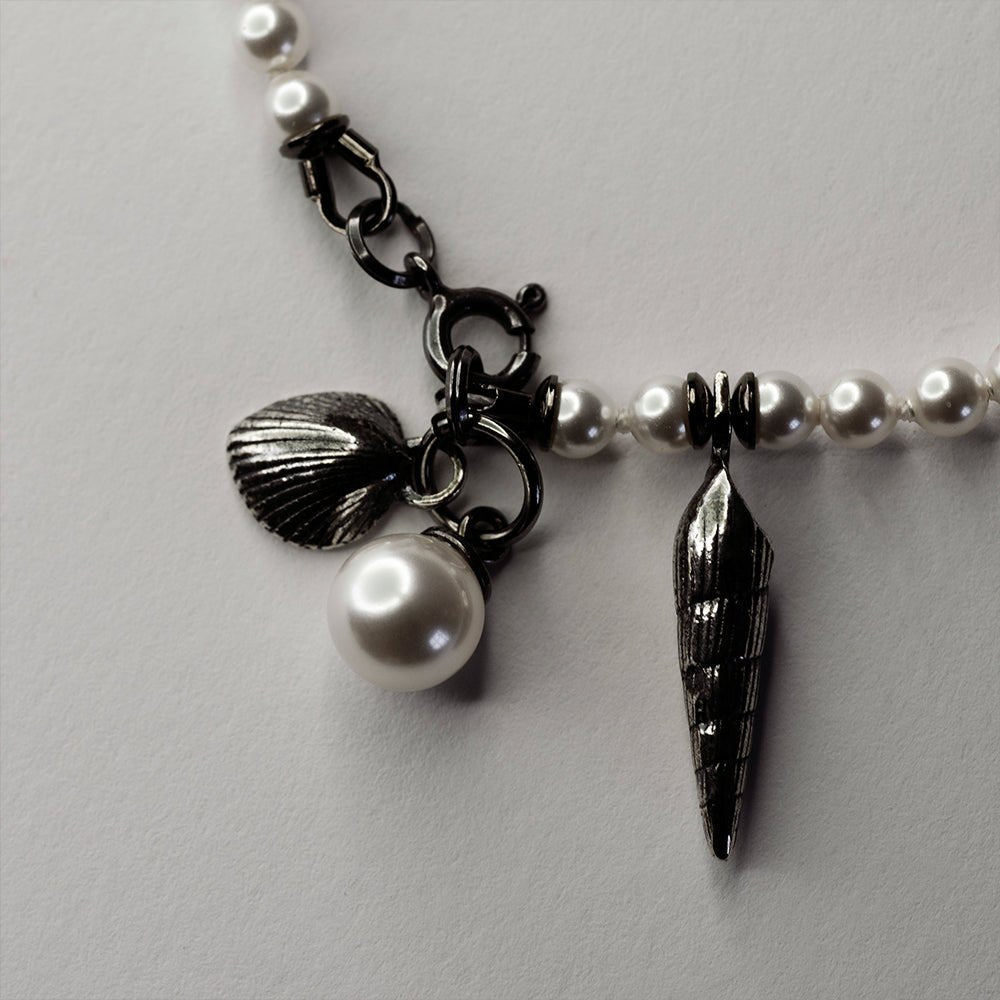 Pearl & Shell Bracelet - placed on white surface, close up of shells with detailed texture visible
