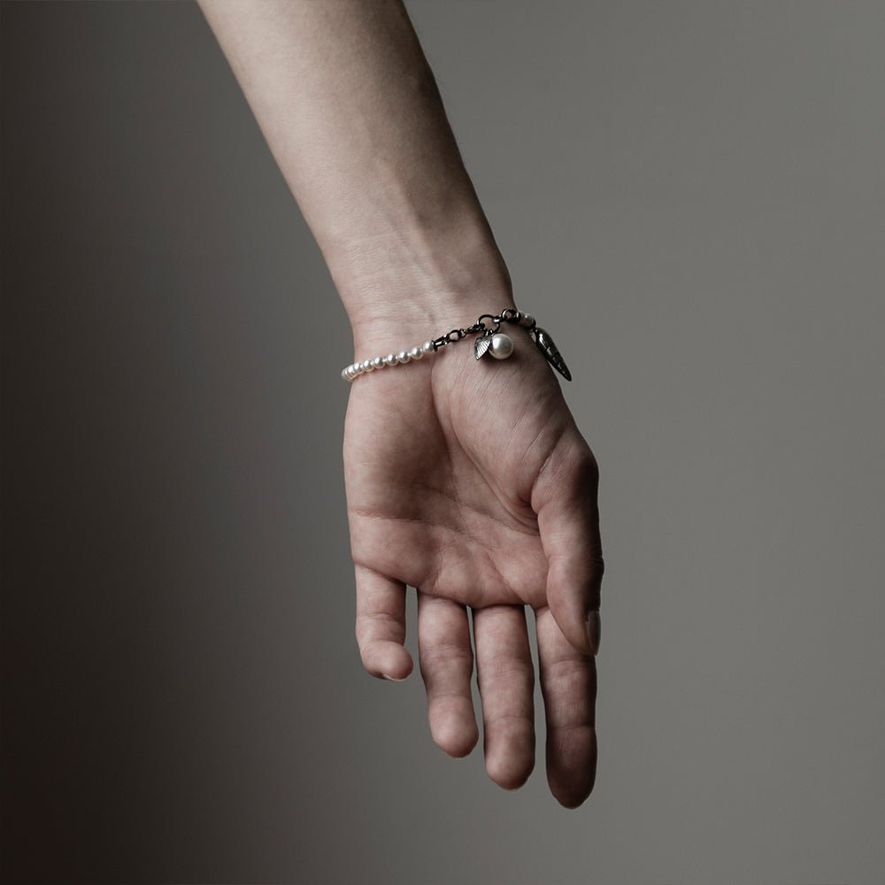 Pearl & Shell Bracelet on a woman's hand, back of the hand is visible to display general fit and dimensions from different angle