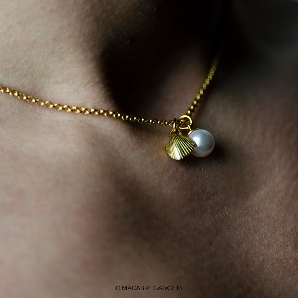 Close-up of  gold-plated Shell & Pearl pendant on model's neck - mermaid inspired necklace styling shot