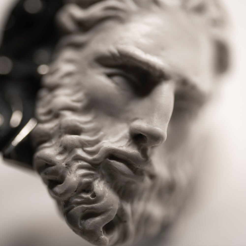 Silver Zeus ring close-up — sculpted marble face of Zeus, beard and hair detail, handcrafted greek god ring in sterling silver