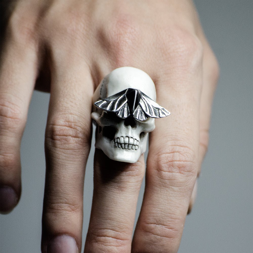 Skull & Moth ring - white variant - on a model's hand, close up