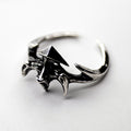 Vertebra ring - gothic sterling silver ring in shape of vertebrae and a pair of ribs on white surface
