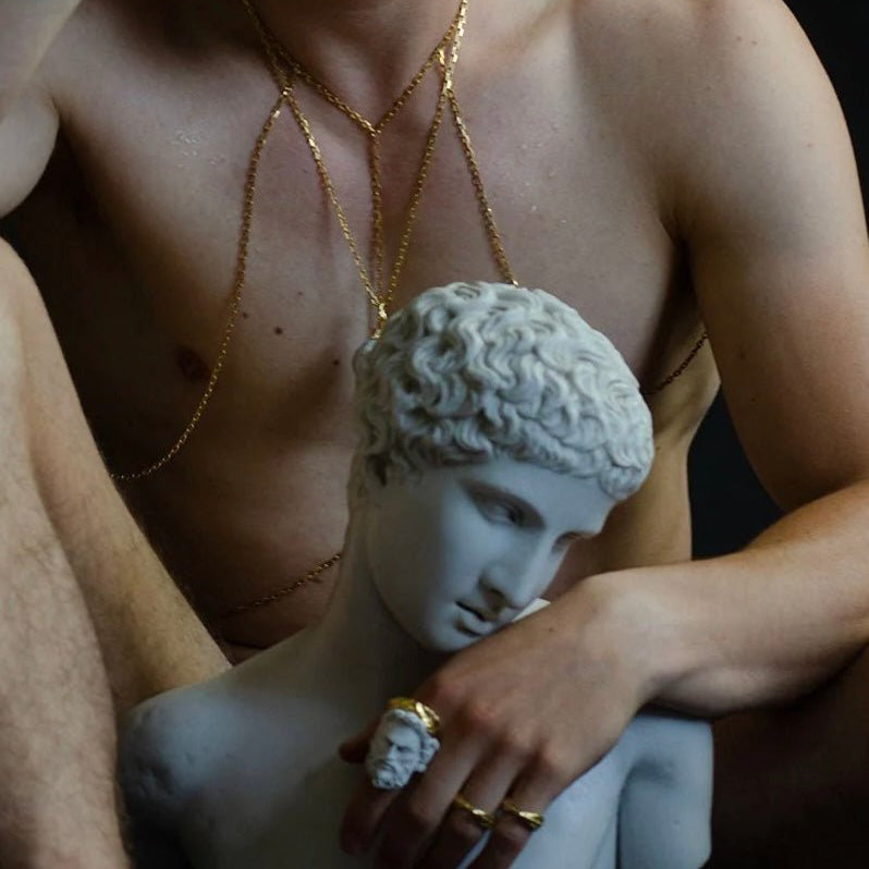 Zeus ring on a male model  behind ancient greek sculpture,  from fashion editorial 